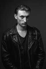 Fototapeta na wymiar Portrait of the handsome young man in leather jacket. Black and white.