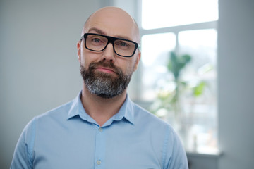 Bearded middle-aged man wearing glasses.