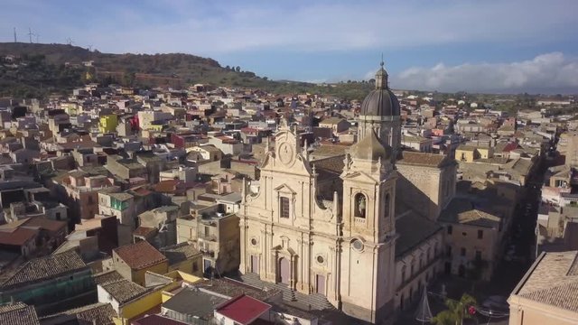 25P flying past cathedral in Militello Sicily