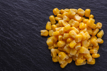 canned corn on a dark stone background