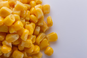 Canned corn on a white acrylic background
