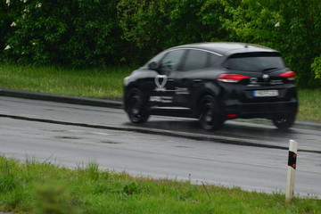 Fast moving car (blurred) in germany on a rainy day in april
