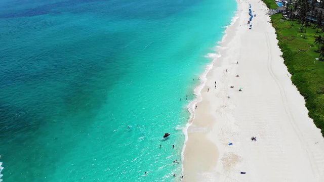Paradise Island, Bahamas - Clear turquoise water and green palm trees The breathtaking beauty of the Bahamas. Sugar-fine white sand, clear, turquoise waters and the incredible golf courses.