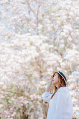Obraz premium spring season with full bloom pink flower travel concept from beauty asian woman enjoy with sight seeing sakura or cherry blossom with soft focus flower background