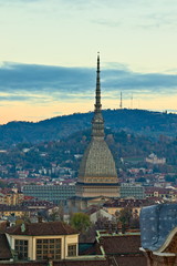 Aerial view from the bell tower of the Cathedral towards the Mole Antonelliana with background on the hills beyond the river Po, at sunset, Turin, Piedmont, Italy