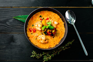 Tom Yam kung Spicy Thai soup with shrimp, seafood, coconut milk and chili pepper in bowl copy space