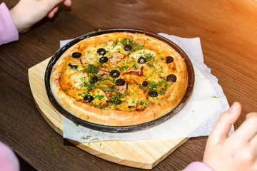 fast food, italian kitchen and eating concept - close up of homemade pizza on wooden table