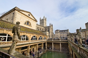 Fototapeta na wymiar Bath, Somerset, England - December 24, 2018: The Roman Baths complex is a site of historical interest in the English city of Bath. It is a well-preserved Roman site once used for public bathing.