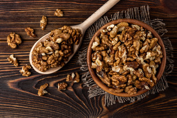 Walnut on dark wooden background.