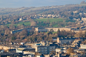 Fototapeta na wymiar Aerial view of the Royal Crescent, a row of 30 terraced houses laid out in a sweeping crescent, in Bath, Somerset, England, in the afternoon near sunset