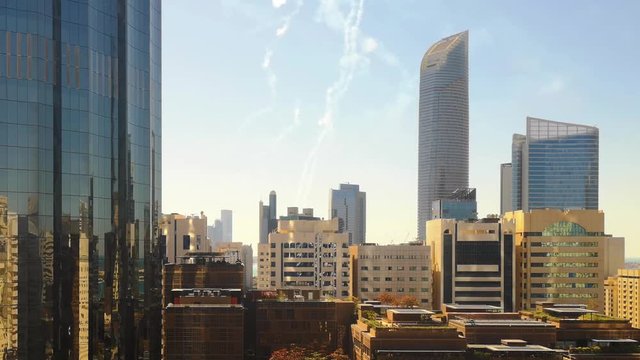 Airplane race show in Abu Dhabi city corniche street - Aerial city skyline view and plane smoke