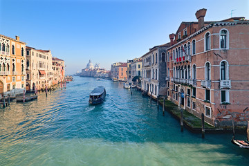 Fototapeta premium View of the Grand Canal in Venice, Italy, from the Ponte dell'Accademia, with a ferry crossing the canal