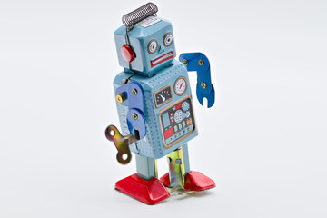 Grey vintage old wind up toy robot isolated on white limbo background