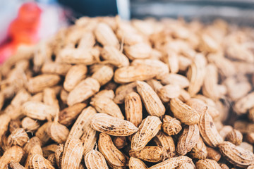 Bunch of cooked peanuts in shells. Selected focus. Copy space.