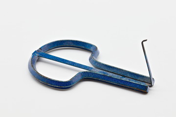Blue metal Jew's harp, also known as the jaw, mouth , Ozark or juice harp. It is a lamellophone instrument, consisting of a flexible metal or bamboo tongue or reed attached to a frame