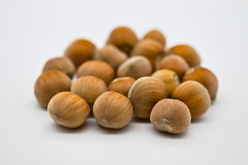 group of brown hazelnuts isolated on white limbo background