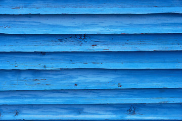 Obraz premium Blue painted plank fence with cracked and scratch. Horizontal grunge texture