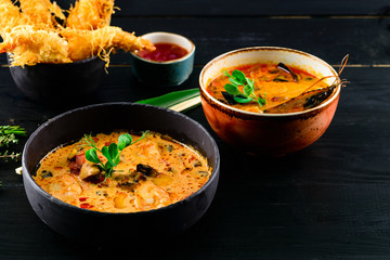 Tom Yam soup and seafood soup, Pan-Asian menu in restaurant. Top View.