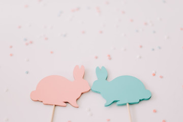 Happy Easter concept. Two bunny toy on white background.  Easter decoration. Close up, top view. copy space