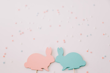 Happy Easter concept. Two bunny toy on white background.  Easter decoration with rabbits. Close up, top view. copy space