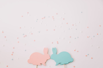 Happy Easter concept. Two bunny toy on white background. Easter decoration with rabbits. Close up, top view. copy space