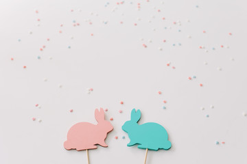 Happy Easter concept. Two bunny toy on white background. Easter holiday background, spring season. Easter decoration with rabbits. Close up, top view. copy space
