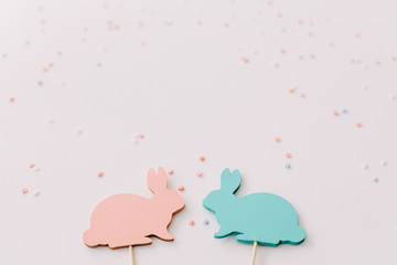 Happy Easter concept. Two bunny toy on white background. Easter holiday background, spring season. Easter decoration with rabbits. Close up, top view. copy space