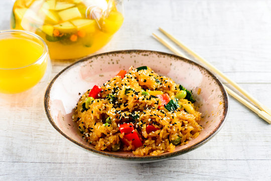 Asian cuisine - Tori tyahan. Fried rice with chicken meat, vegetables and radishes in bowl.