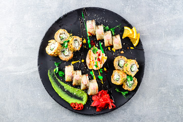 asian sushi set on wide plate, ready meal to eat, seafood