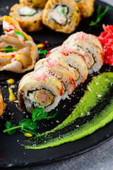 Sushi roll on a plate topped with pea sprouts