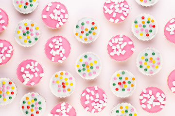 Colorful cupcakes on a white background.
