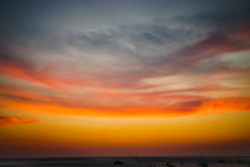 Fototapeta premium Scene of sunset at sea with cloudy red sky and boats in the water. Tourism Background