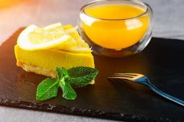 Close up a piece of lemon meringue cheese cake on white plate and white table for afternoon tea at cafe or restaurant