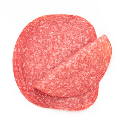 Salami slices on white background.