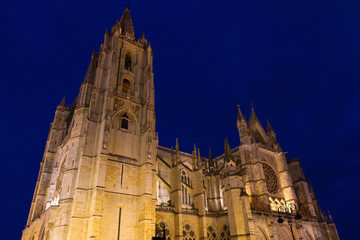 Fototapeta premium Cathedral of Leon. Gothic monument with blue sky and illumination lit at nightfall