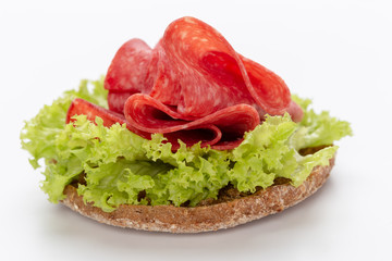 Sandwich with salami sausage on white background.
