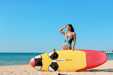 Obraz premium A Surf girl with long hair go to surfing. Outdoor Active Lifestyle