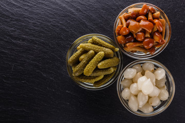 pickled vegetables on a dark stone background
