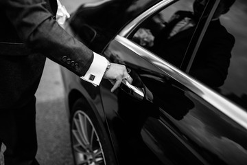 Hand on handle. Close-up of Asian man hand opening / close a car door, chauffeur car service...