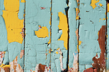 cracked old paint on wooden boards. Turquoise and yellow