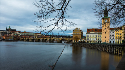 View of the famous Charles Bridge in Prague with inter sky and caster in the background