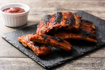 Grilled barbecue ribs on wooden table