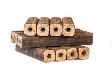 Fuel briquettes folded in rows on a white background. Wooden  briquettes are an environmentally friendly fuel source that are used to start a fire. They are made by pressing of dry sawdust.