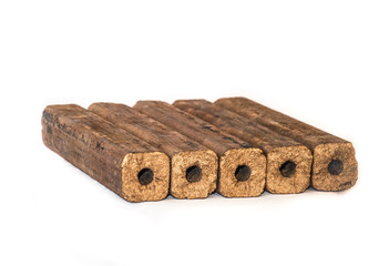 Fuel briquettes folded in rows on a white background. Wooden  briquettes are an environmentally...