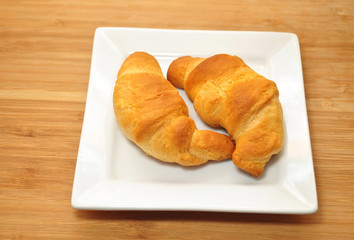 Two Fresh Baked Organic Croissant Rolls On a Plate