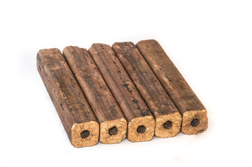 Fuel briquettes folded in rows on a white background. Wooden  briquettes are an environmentally friendly fuel source that are used to start a fire. They are made by pressing of dry sawdust.