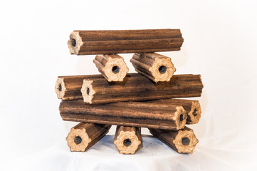 Fuel briquettes folded in rows on a white background. Wooden  briquettes are an environmentally friendly fuel source that are used to start a fire. They are made by pressing of dry sawdust.