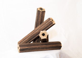 Fuel briquettes folded in rows on a white background. Wooden  briquettes are an environmentally...