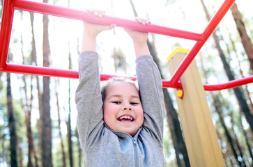 little girl playing in an amusement park real children's emotions of joy
