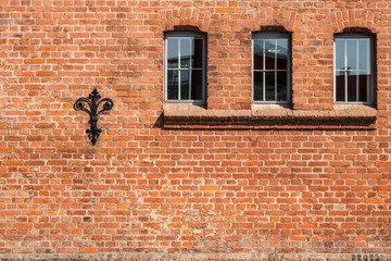 Walls and windows.Old brick wall with three windows.